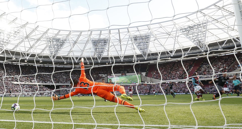  Adrian cannot keep out Charlie Austin's strike at full stretch