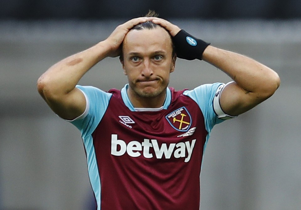  West Ham skipper Mark Noble holds his head as his side are defeated