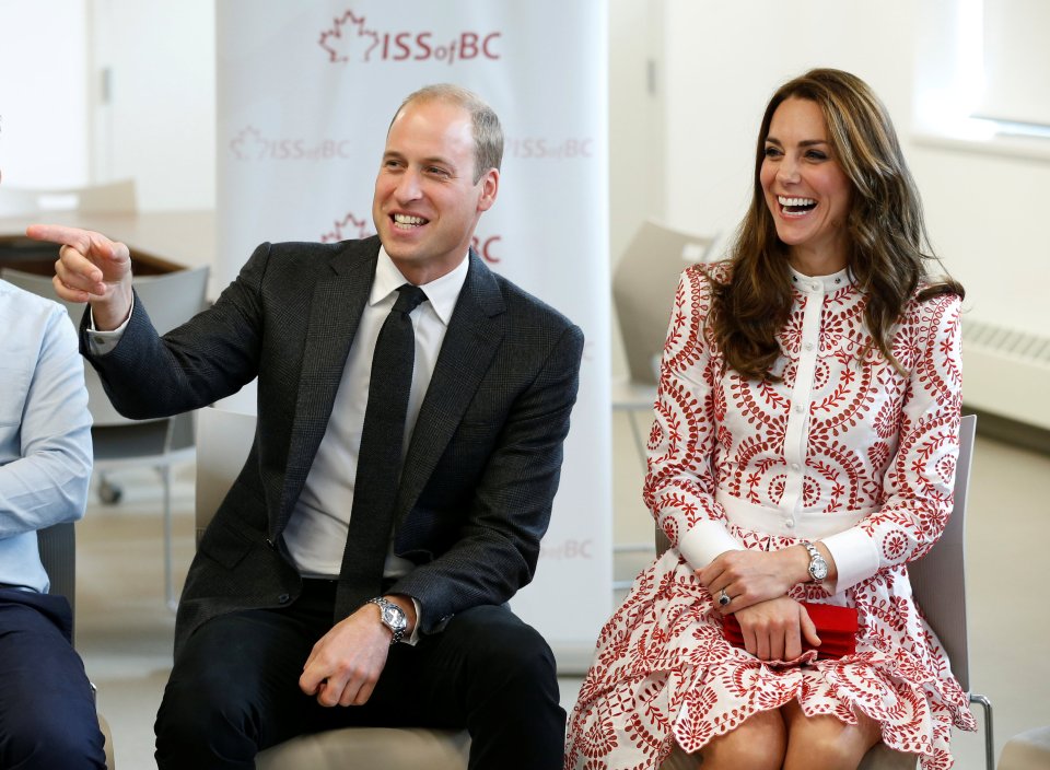 The royal couple laugh as they watch children play at the centre during their visit