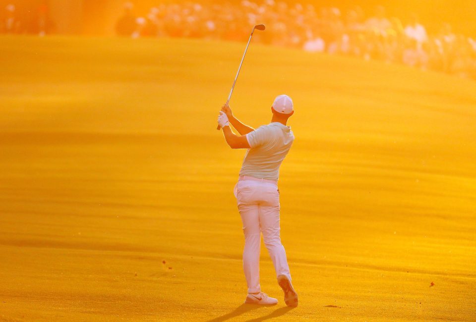  Rory McIlroy holds his pose as he watches his shot hit the green in the evening sunshine