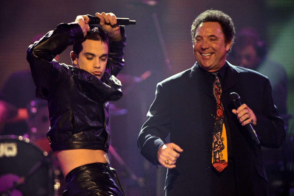  Robbie Williams putting on a show with Tom Jones at The Brit Awards