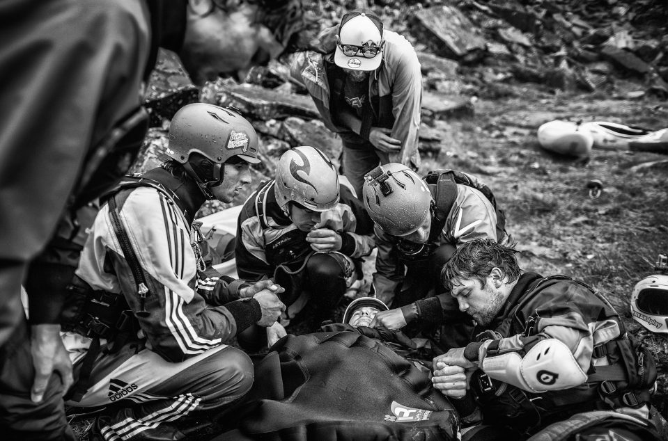  Won by Dean Treml from New Zeland with this photo of Josh Neilson being supported by fellow paddlers as he waits for a helicopter evacuation after a bad landing off Matze's Drop, Storulfossen, Norway