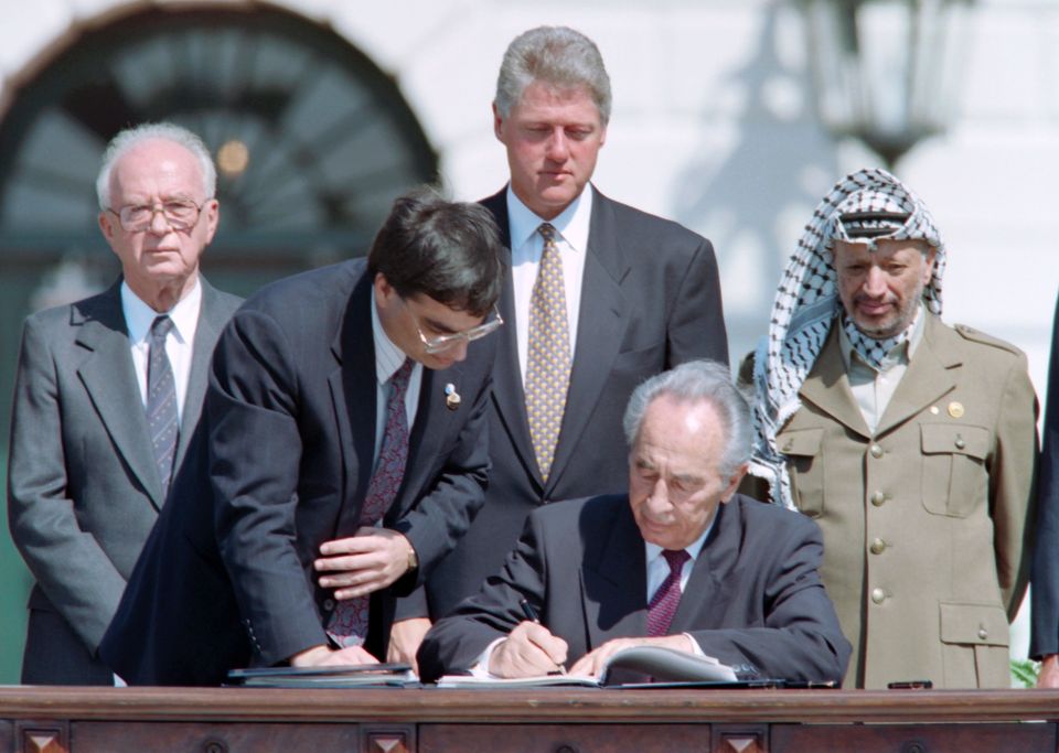 Peres, then Israel's foreign minister, signs Oslo Accords with Yasser Arafat, Yitzhak Rabin and Bill Clinton