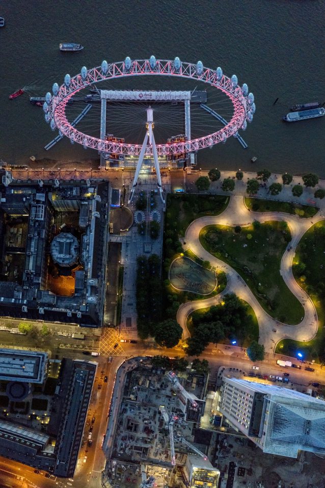  The London Eye on the Southbank is lit up in pink as dusk falls over the capital