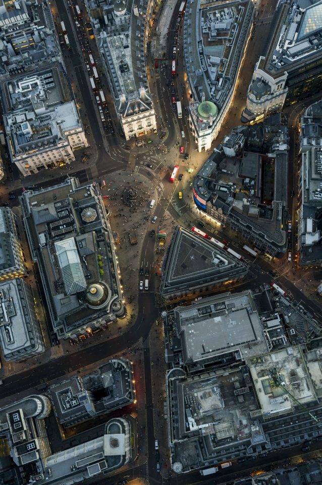  Tourists and shoppers throng round the statue of Eros at Piccadilly Circus in the West End