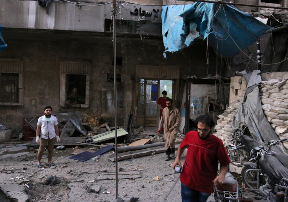  Medics assess the damage following an airstrike in a rebel-held area of Aleppo