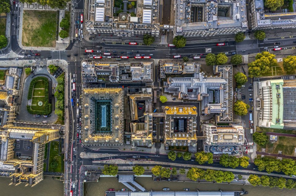  Red London buses line up between government buildings near the Palace of Westminster and Big Ben, far left, and the green-roofed Ministry of Defence, right