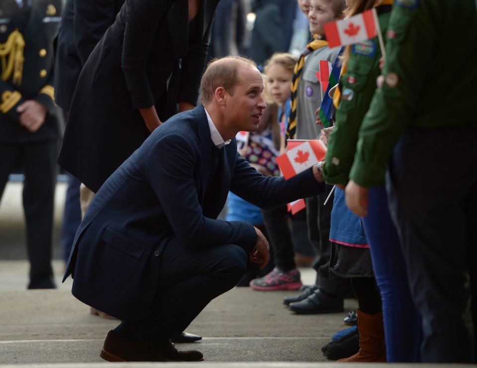 William crouched down to greet some local schoolchildren during the visit