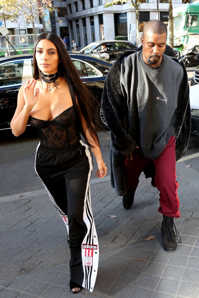  Kim Kardashian paired a black lace corset with a pair of Adidas poppers for a Paris fashion show