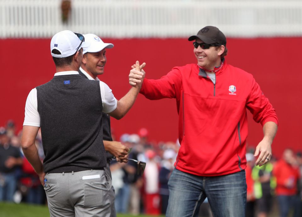 The heckler is congratulated by Team Europe stars after making the putt