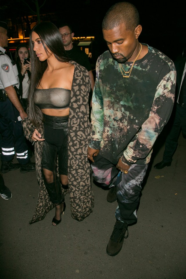 Glum looking Kanye kept his head low while his wife took control of the spotlight 