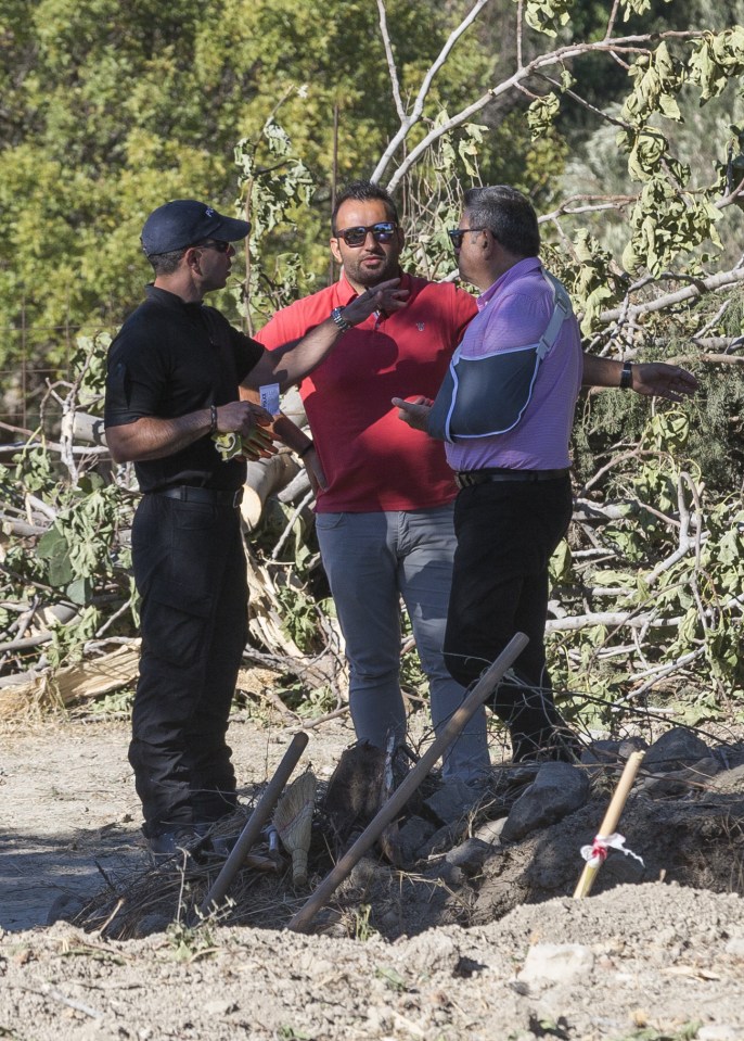  Landowner Stefanos Troumouhis (centre) and his lawyer speak to police at the site this morning