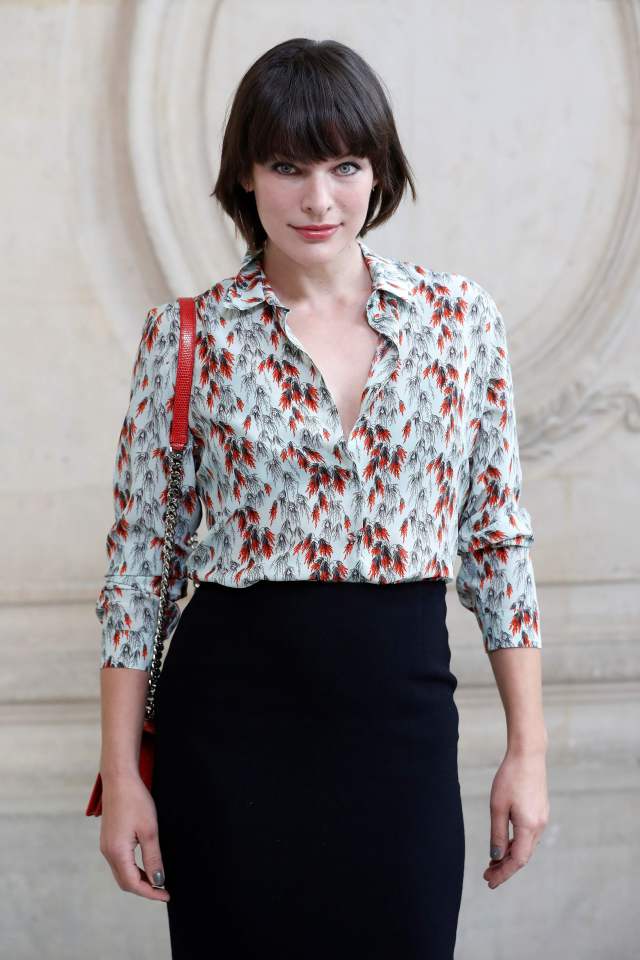  Milla Jovovich wore a patterned blouse tucked into a black skirt