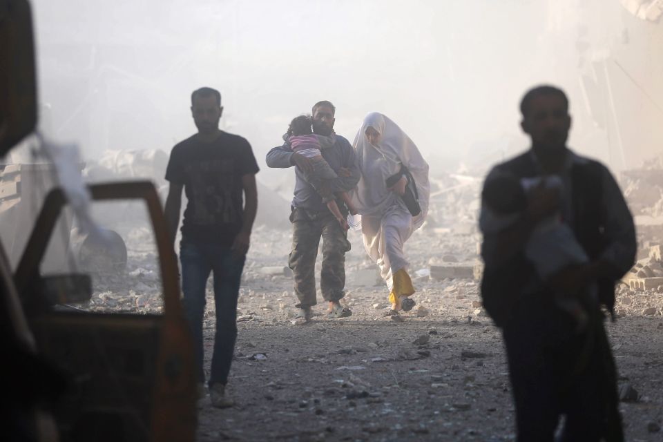  Victims emerge from a dust cloud after the alleged strike