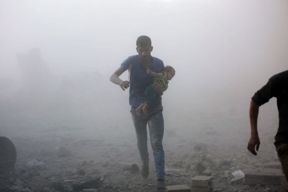  A father carries his child amid the chaos