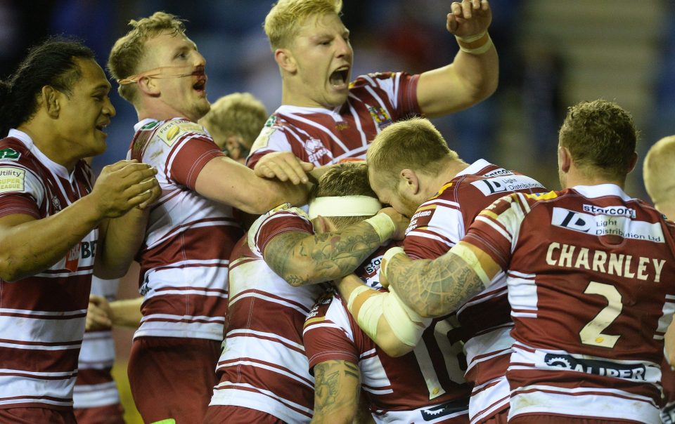 Wigan Warriors players celebrate after Sam Powell scores the crucial try