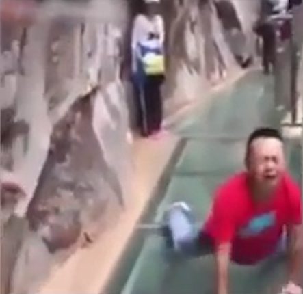  One man screams in terror as he crosses the walkway on his belly