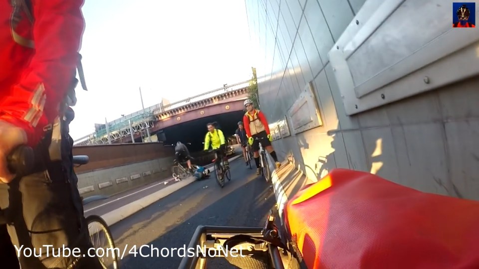  A third cyclist, wearing black, fell over tried avoid the male rider's body on the ground