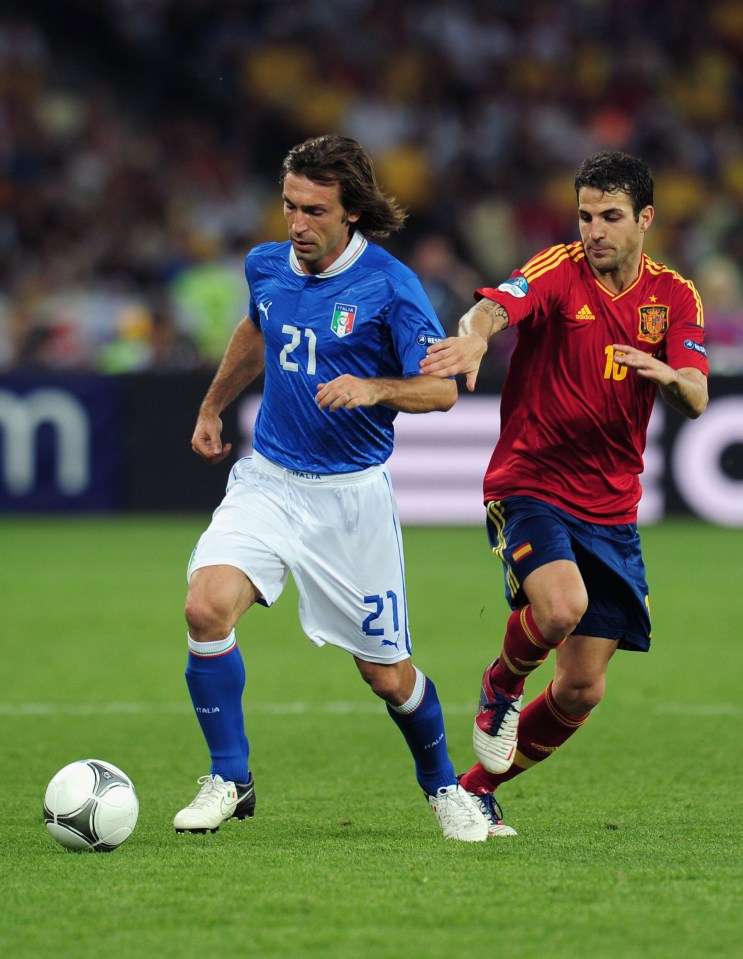 KIEV, UKRAINE - JULY 01: Andrea Pirlo (L) of Italy and Cesc Fabregas of Spain battle for the ball during the UEFA EURO 2012 final match between Spain and Italy at the Olympic Stadium on July 1, 2012 in Kiev, Ukraine. (Photo by Shaun Botterill/Getty Images)