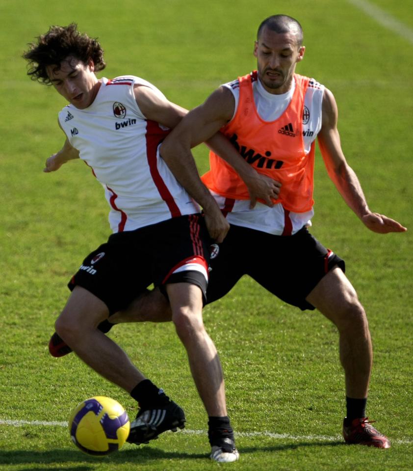 AC Milan's Matteoa Darmian (L) and Gianluca Zambrotta fight for the ball during a training session at Al-Nasr's club ground in Dubai on January 2, 2009. Italian football giants AC Milan arrived on December 29 to start their winter training camp in the Gulf emirate that will culminate in the Dubai Football Challenge match against German team Hamburg. AFP PHOTO/MARWAN NAAMANI (Photo credit should read MARWAN NAAMANI/AFP/Getty Images)