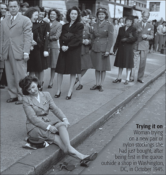  Woman trying on a new pair of nylon stockings she had just bought, after being first in the queue outside a shop in Washington, DC, in October 1945.