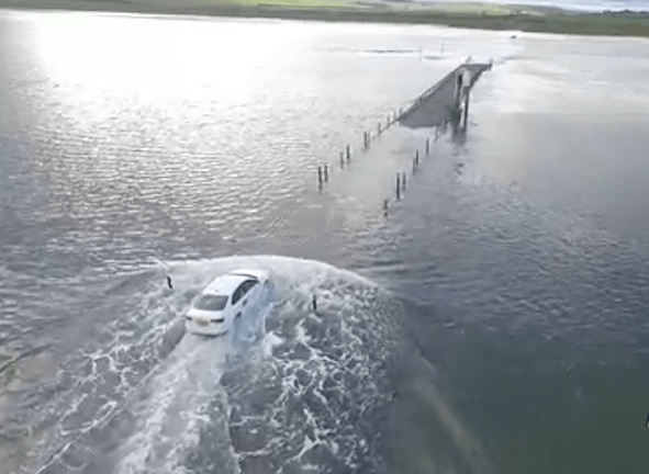  Footage shows the desperate cabbie racing against the tide to get back to land