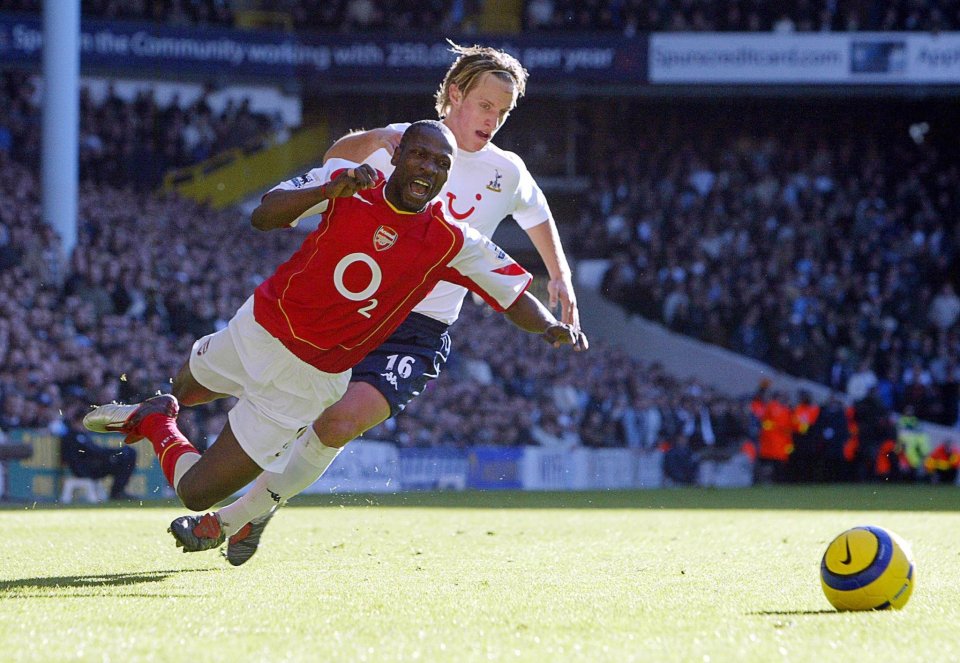 Tottenham Hotspurs' Reto Ziegler (R) tackles Lauren of Arsenal during their Premiership match at White Hart Lane in London 13 November 2004. AFP PHOTO Adrian DENNIS (english premier league (EPL) pictures - 'no telcos, websites uses subject to description of licence with FAPL on www.faplweb.com' football league (fl) games - worthington cup - 'no telcos') (Photo credit should read ADRIAN DENNIS/AFP/Getty Images)