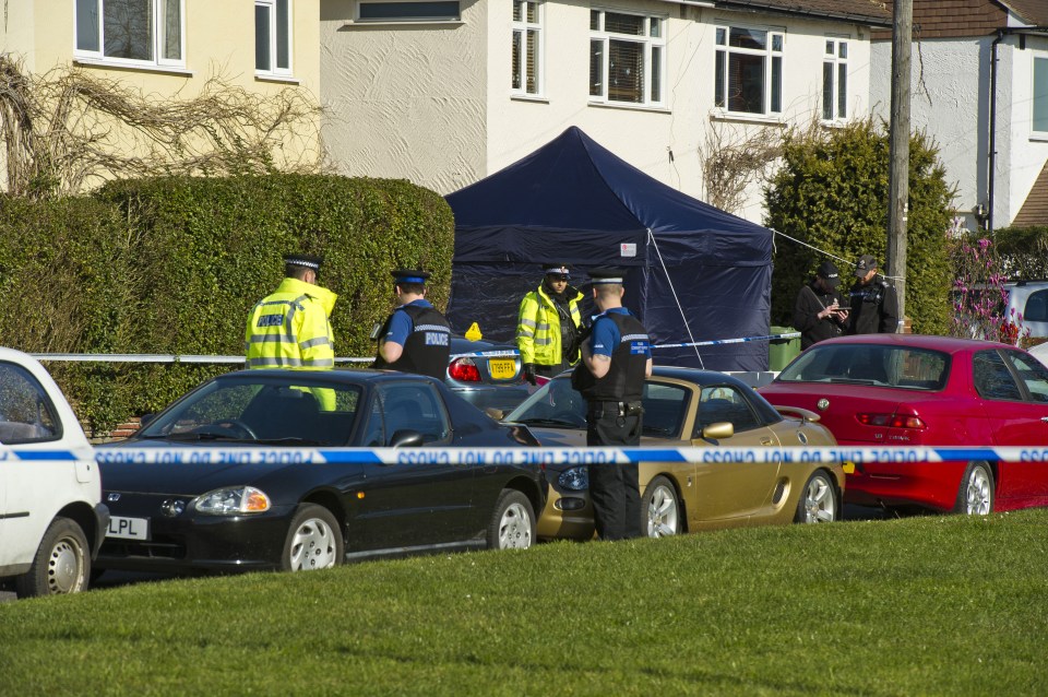  Cops rope off the area near the family home following the killing earlier this year