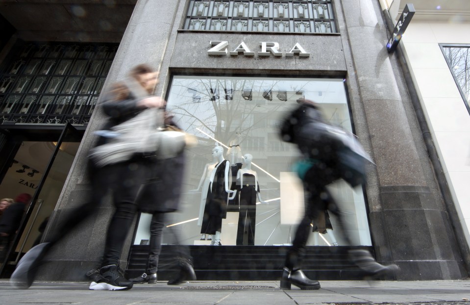 People walk past a Zara store in Nice