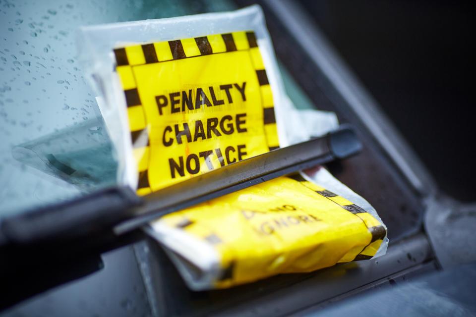 Parking ticket penalty charge notice on the windscreen under a wiper blade traffic ticket windshield ticket parking car ticket