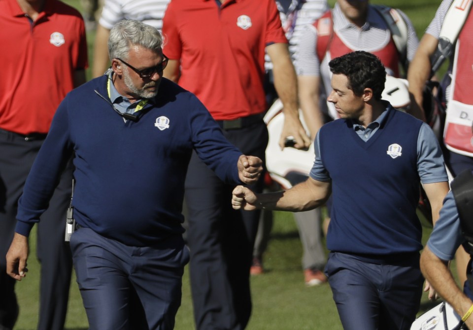  Darren Clarke and Rory McIlroy bang fists as the Europe fightback gets underway