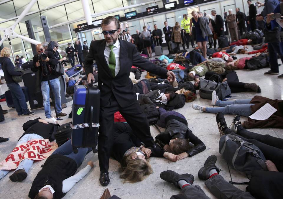  A passenger steps around the demonstrators