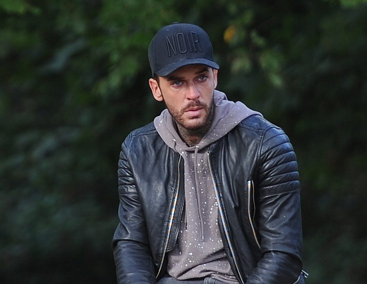  The tattooed hunk looked very sorry for himself as he walked his dog in Essex