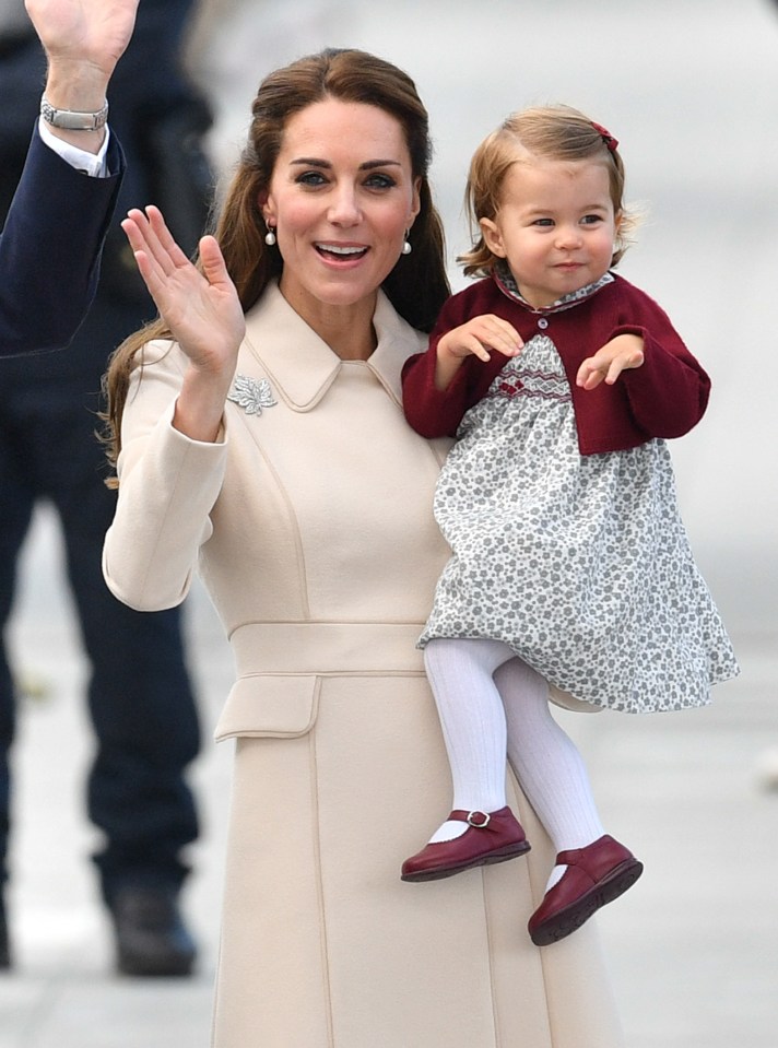 Kate and Charlotte wave to the thousands of well-wishers at Victoria Harbour