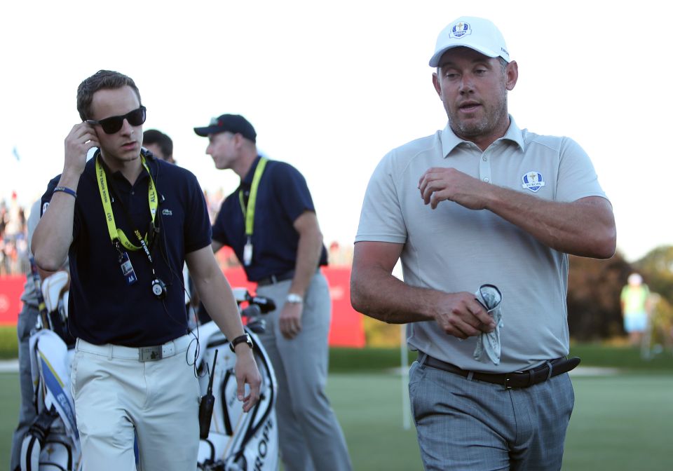  A shellshocked Lee Westwood leaves the 18th green after missing his short putt