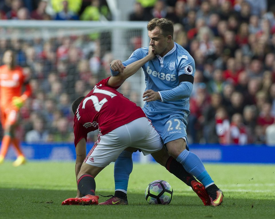  Ander Herrera rides a tackle with Xherdan Shaqiri keeping close tabs