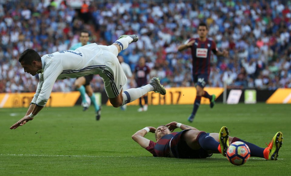  Cristiano Ronaldo tumbles over and Eibar star Florian Lejeune during the 1-1 draw on October 2