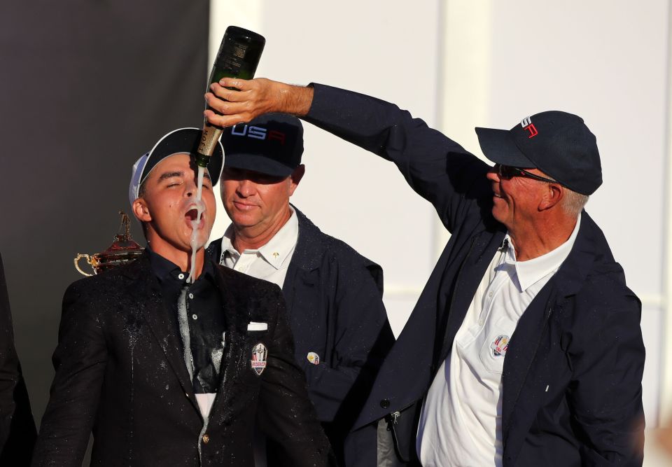  Rickie Fowler gets champagne poured over him by Tom Lehman