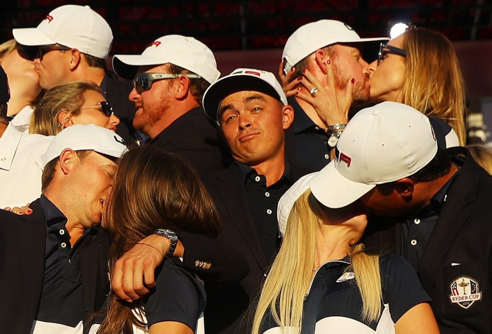  Rickie Fowler, who didn't take a Wag to the Ryder Cup, looks lonely as Kim Johnson, Zach Johnson, J.B. Holmes, Erica Holmes, Jimmy Walker, Erin Walker, Jordan Spieth, Annie Verret, Justine Reed and Patrick Reed enjoy a kiss