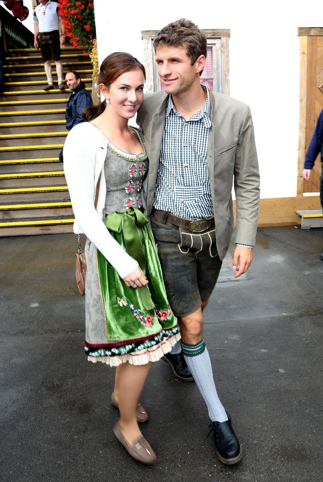 But Thomas Muller left all his troubles on the pitch as he attended the world's largest beer festival with wife Lisa