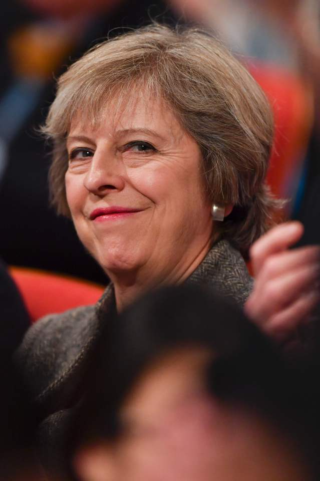  Theresa May looks clearly pleased as Philip Hammond tells the audience the economy is in a strong position