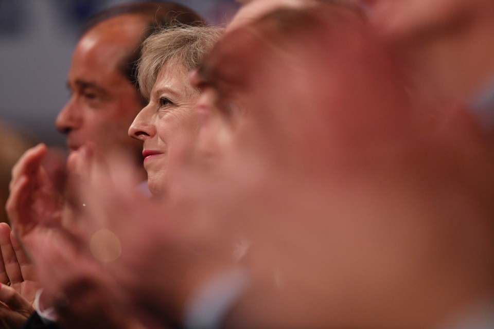  Amidst a sea of faces Theresa May is seen listening intently to her Chancellor's speech on the second day of the Tory Party conference