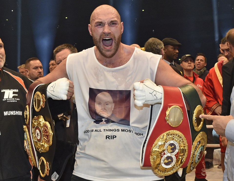  Fury shows off his belts after defeating Wladimir Klitschko