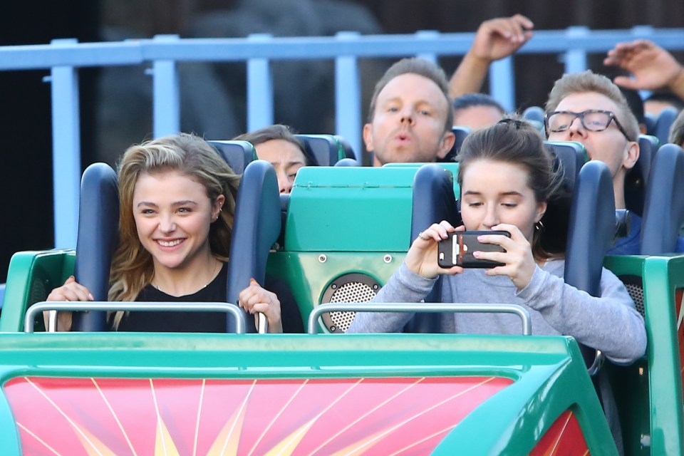  Chloe Grace Moretz gave a rare glimpse of her pearly whites as she enjoyed a day out with pals at Disneyland California