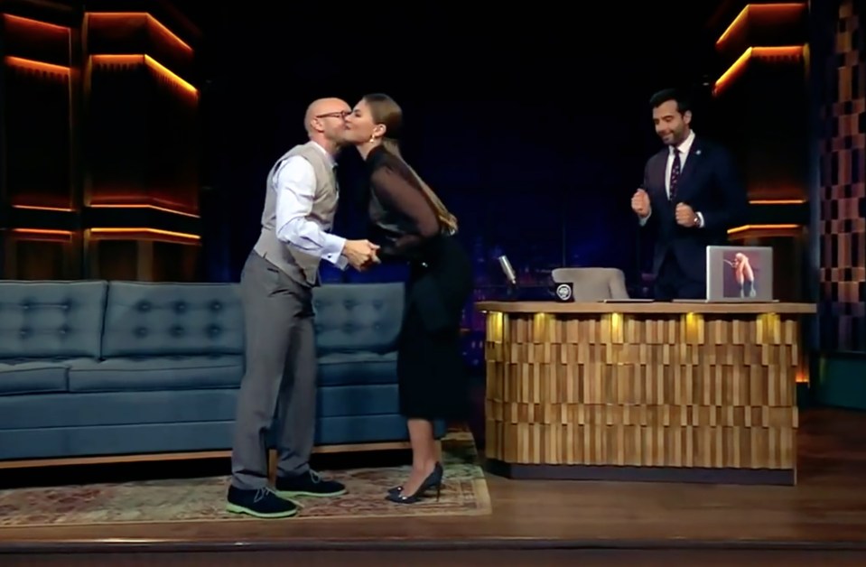  Alina shares a kiss with another guest on the hit show