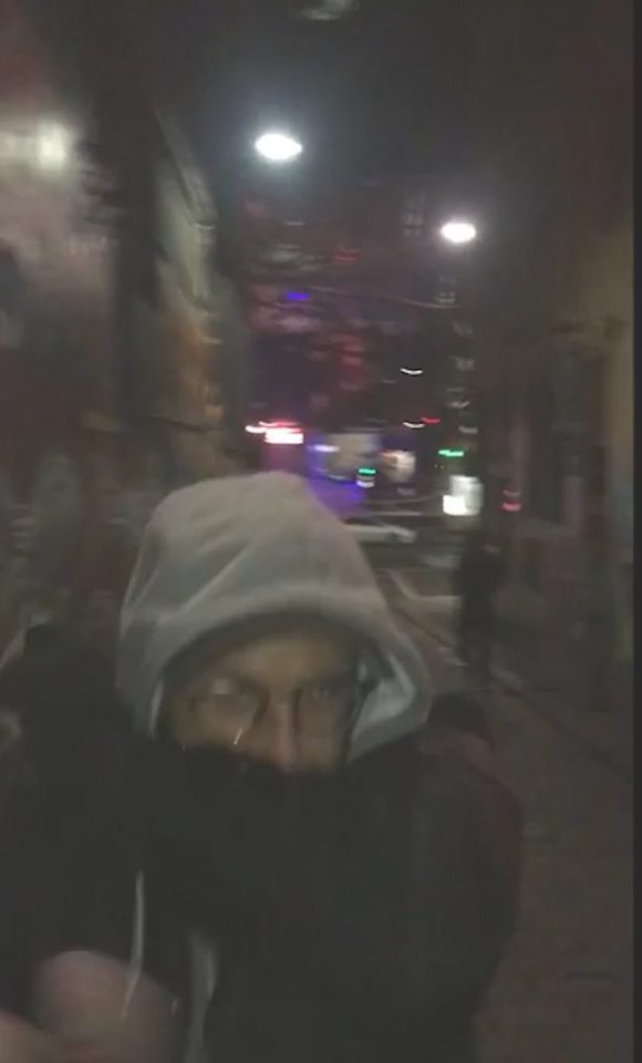  The man, dressed in a hoodie, makes a run for it after he is rumbled down the alley during the middle of the night