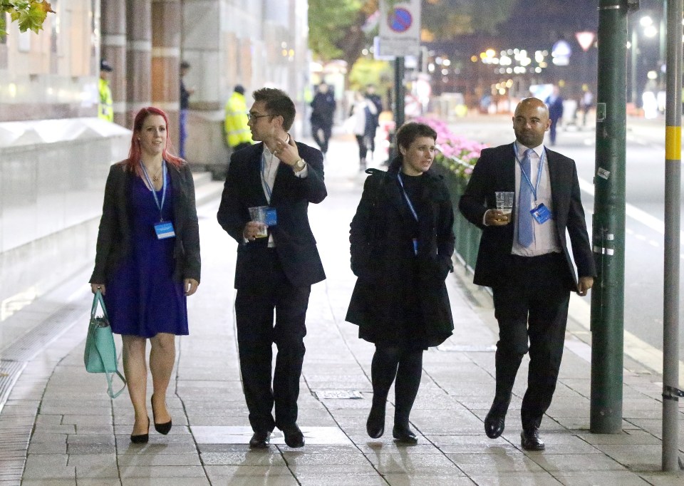  Clutching their drinks in plastic cups the delegates still had their conference passes around their necks as they let their hair down in Birmingham