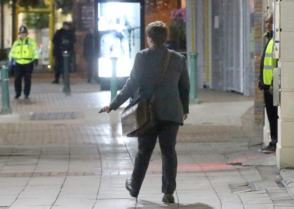  Clutching his phone in his hand a delegate looks like he's calling it a night after a good time at this year's Conservative Party conference