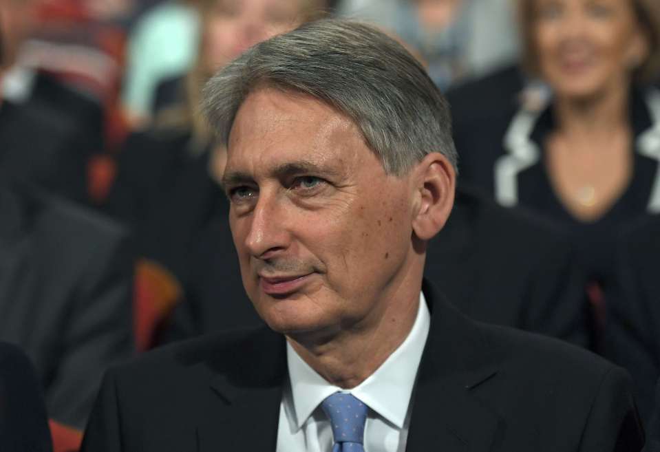 Britain's Chancellor Philip Hammond listens as PM Theresa May gives her speech on the final day of the annual Conservative Party Conference in Birmingham