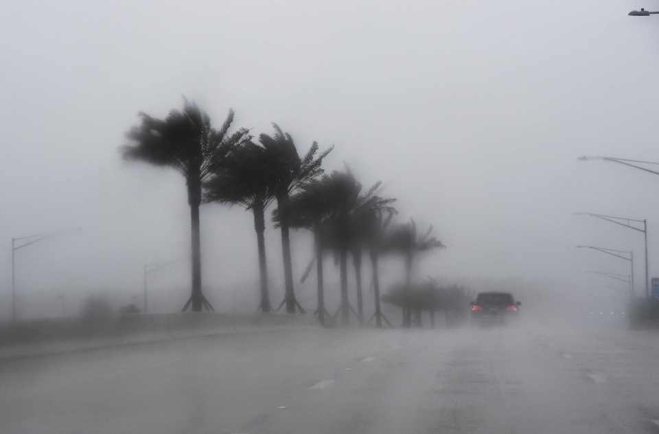 Commuters make their way through heavy rain in Jacksonville, Florida